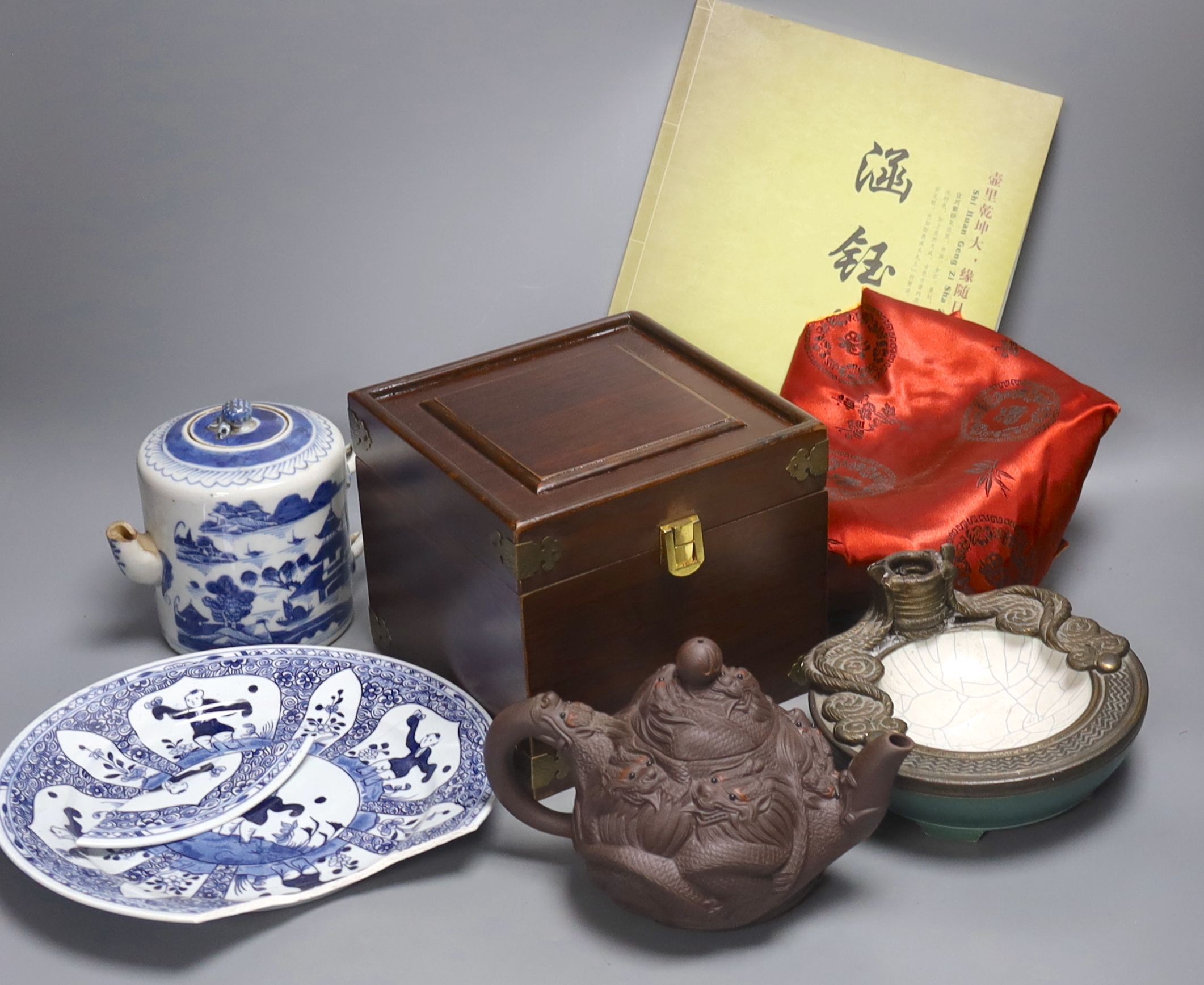 A Chinese Yixing teapot, similar blue and white teapot, blue and white dish and a candle holder, blue and white tea pot 14 cms high.